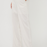 White wide-leg pants worn by a person on a white background