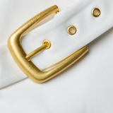 Gold belt buckle on a white background