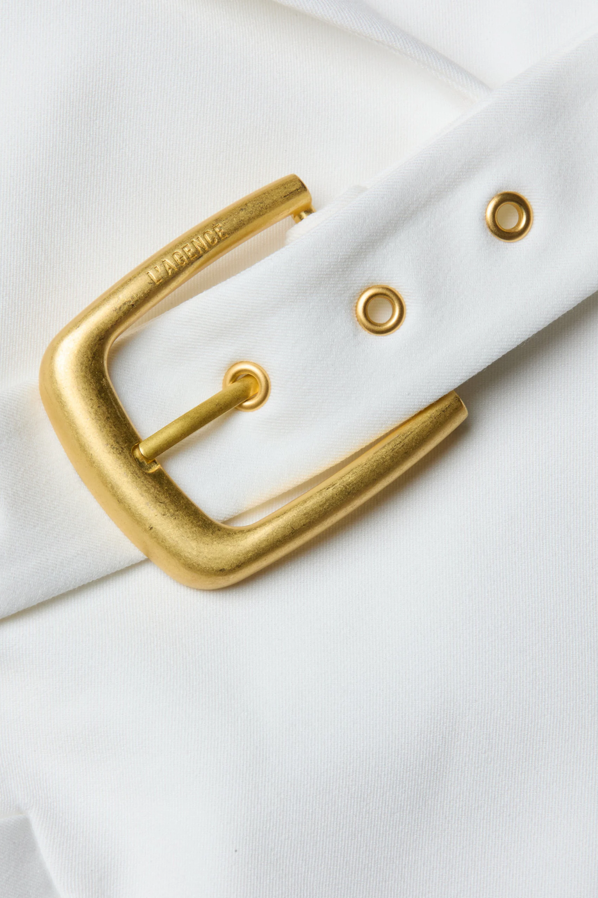 Gold belt buckle on a white background