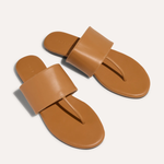 Pair of tan sandals on a white background