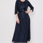 Model wearing a knee-length lace skirt with sequin detailing and a flattering fitted silhouette.