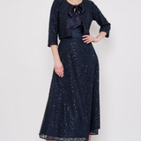 Model wearing a knee-length lace skirt with sequin detailing and a flattering fitted silhouette.