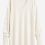 An off-white long-sleeve V-neck sweater with a relaxed fit, displayed on a clean white background.