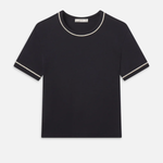 Black t-shirt with white trim on a light gray background