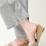 green wedges on woman on white background 