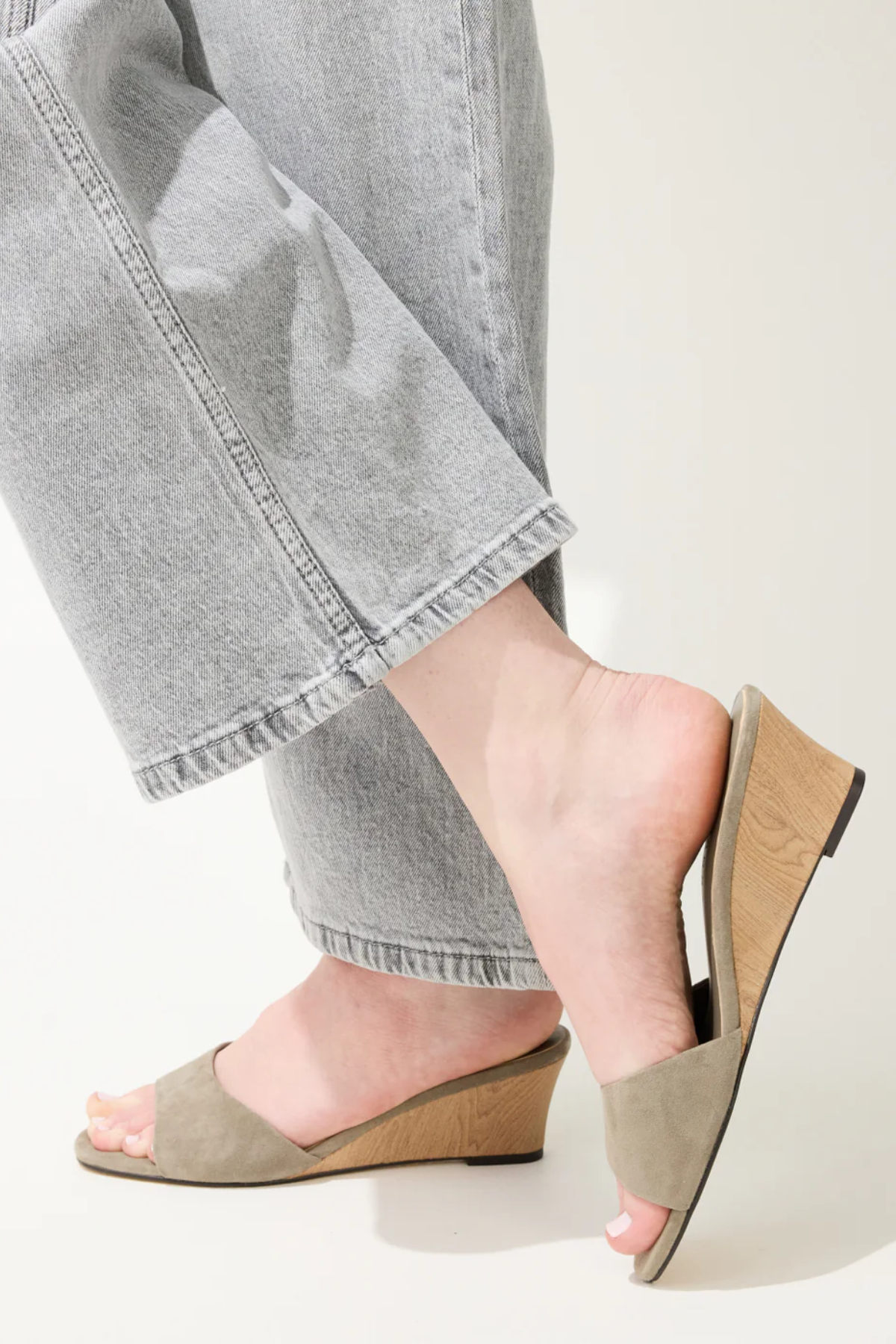 green wedges on woman on white background 