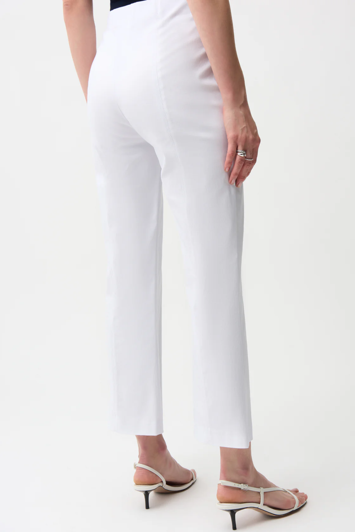 White pants worn by a person on a white background