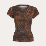 A short-sleeve crewneck t-shirt with a brown and dark brown mottled, mineral-washed pattern, displayed against a light off-white background.