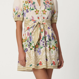 Woman wearing a floral dress with a white background