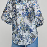 Floral patterned shirt worn by a person on a gray background