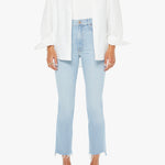 Person wearing a white shirt, light blue jeans, and pink sandals on a white background