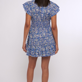 Model wearing a blue printed mini dress with short sleeves and a fitted waist.