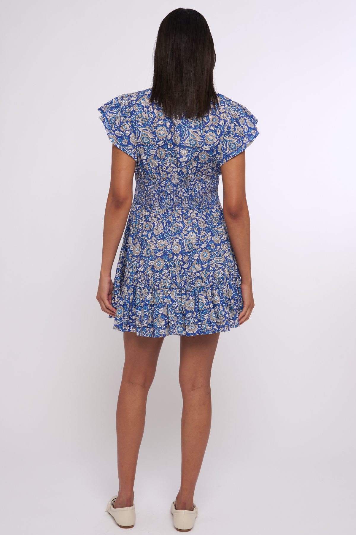 Model wearing a blue printed mini dress with short sleeves and a fitted waist.
