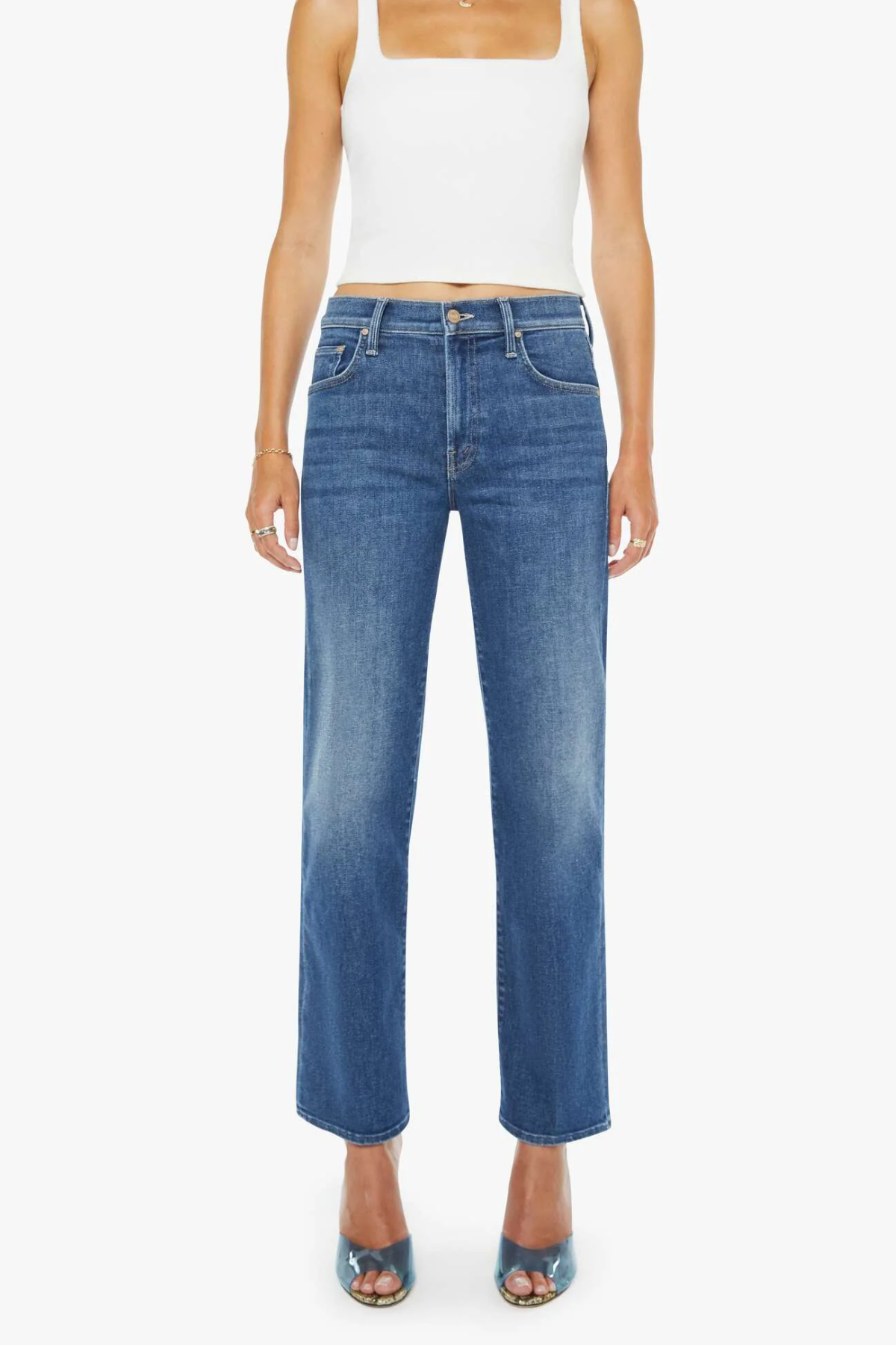 Woman wearing blue jeans and a white top on a white background