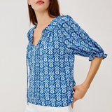 woman in blue printed blouse on white background 