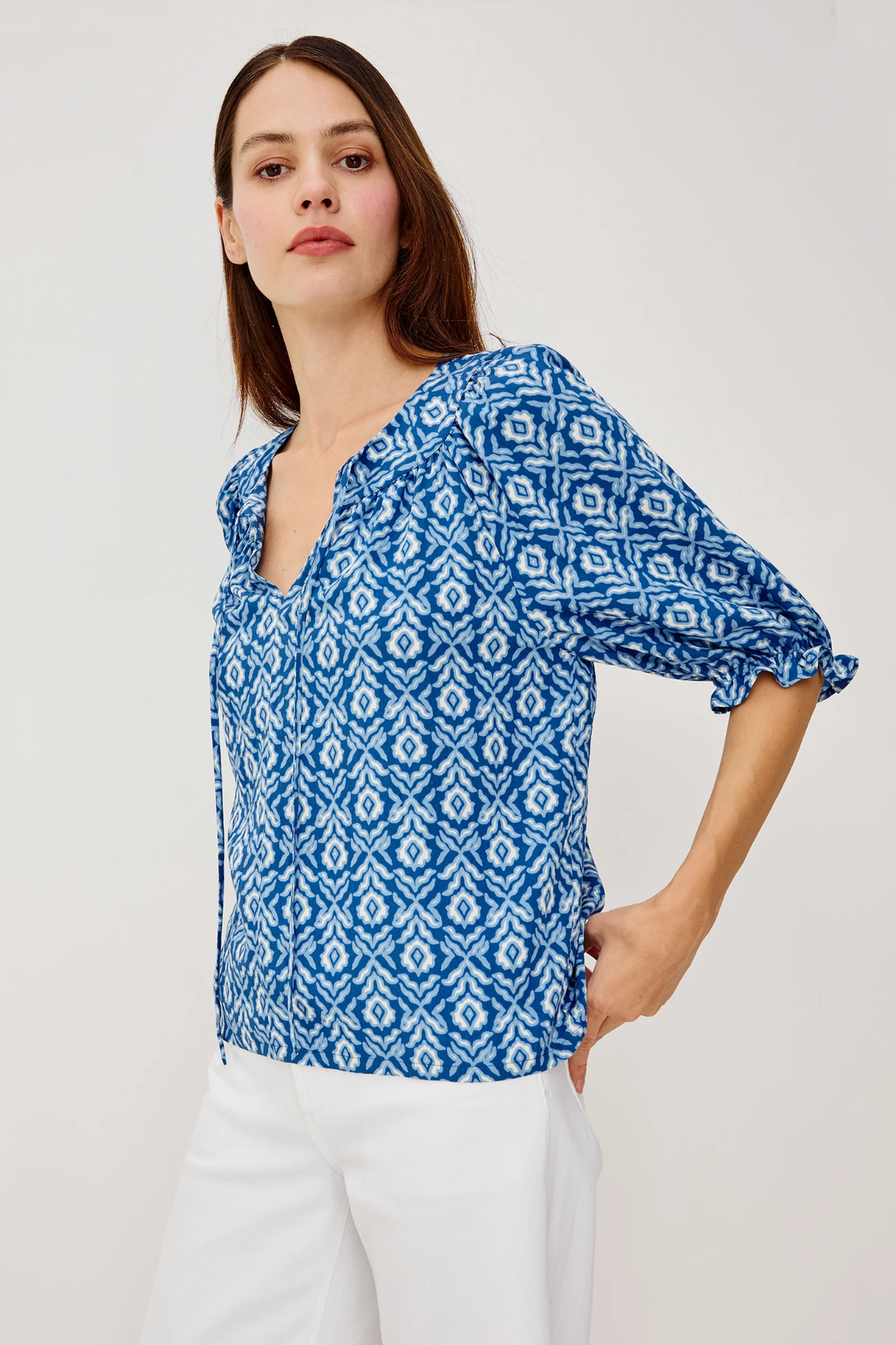 woman in blue printed blouse on white background 