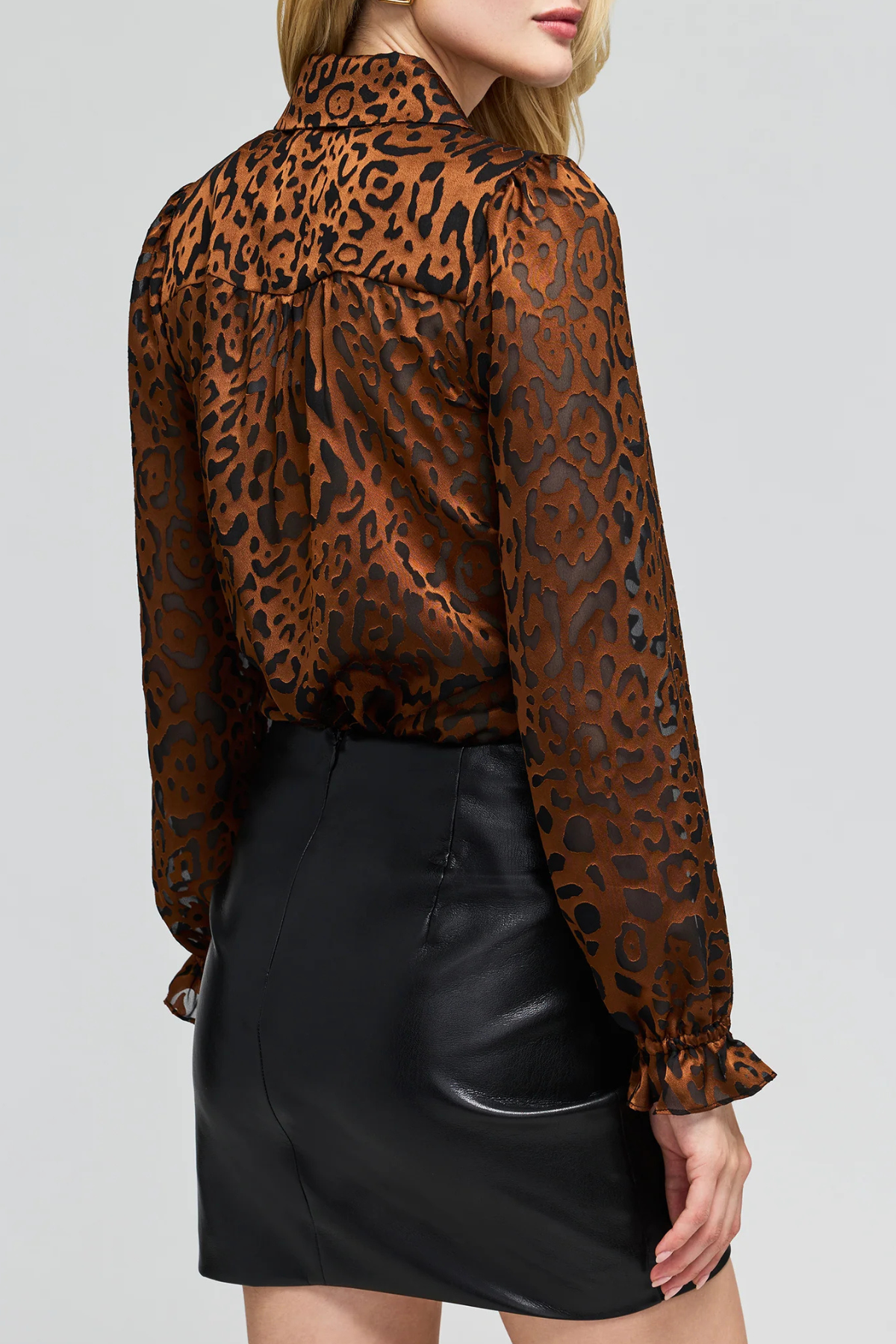 Women's leopard print burnout blouse featuring long sleeves and a semi-sheer textured finish.