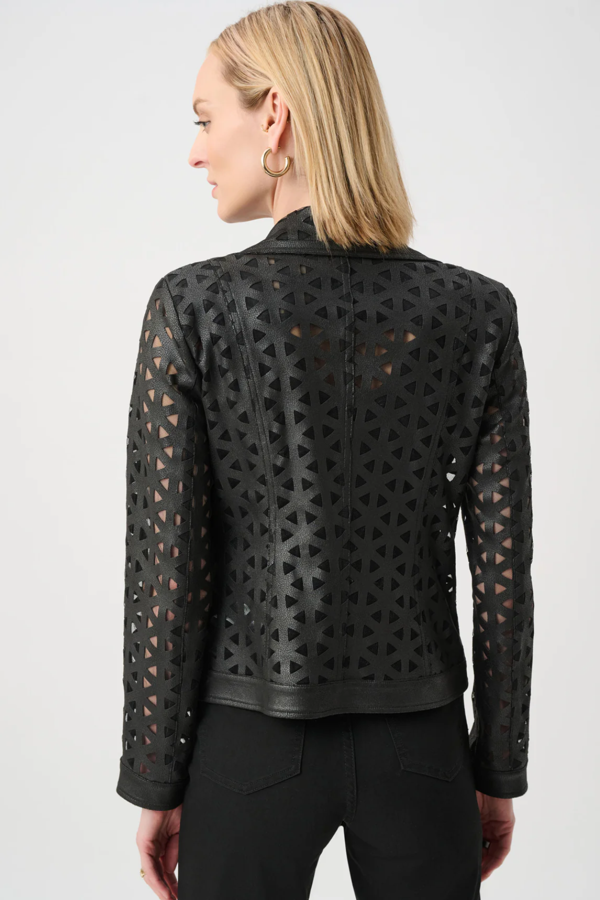 Black perforated leather jacket worn by a person on a white background