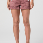 Person wearing pink shorts on a white background