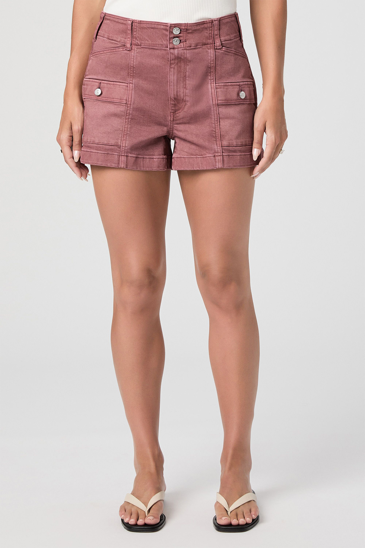 Person wearing pink shorts on a white background