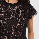 Black lace top on a model against a white background