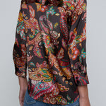 Person wearing l'agence  patterned shirt and jeans on a gray background