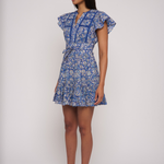 Model wearing a blue printed mini dress with short sleeves and a fitted waist.
