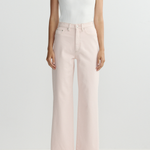 Person wearing a white sleeveless top and light pink wide-leg pants on a white background
