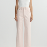 Person wearing a white sleeveless top and light pink wide-leg pants on a white background