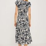 Woman wearing a black and white floral dress on a white background