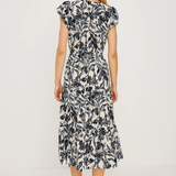 Woman wearing a black and white floral dress on a white background