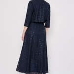 Model wearing a knee-length lace skirt with sequin detailing and a flattering fitted silhouette.
