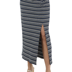 A navy blue midi skirt with thin cream and white horizontal stripes, featuring a front button closure and a high side slit, shown on a model wearing metallic sandals against a white background.