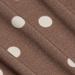 Close-up of brown fabric with white polka dots