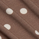Close-up of brown fabric with white polka dots