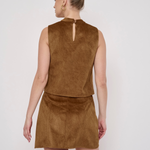 A woman shown from the back wearing a sleeveless brown faux-suede mini dress with a high keyhole neckline and a matching mini skirt, against a plain light gray studio background.