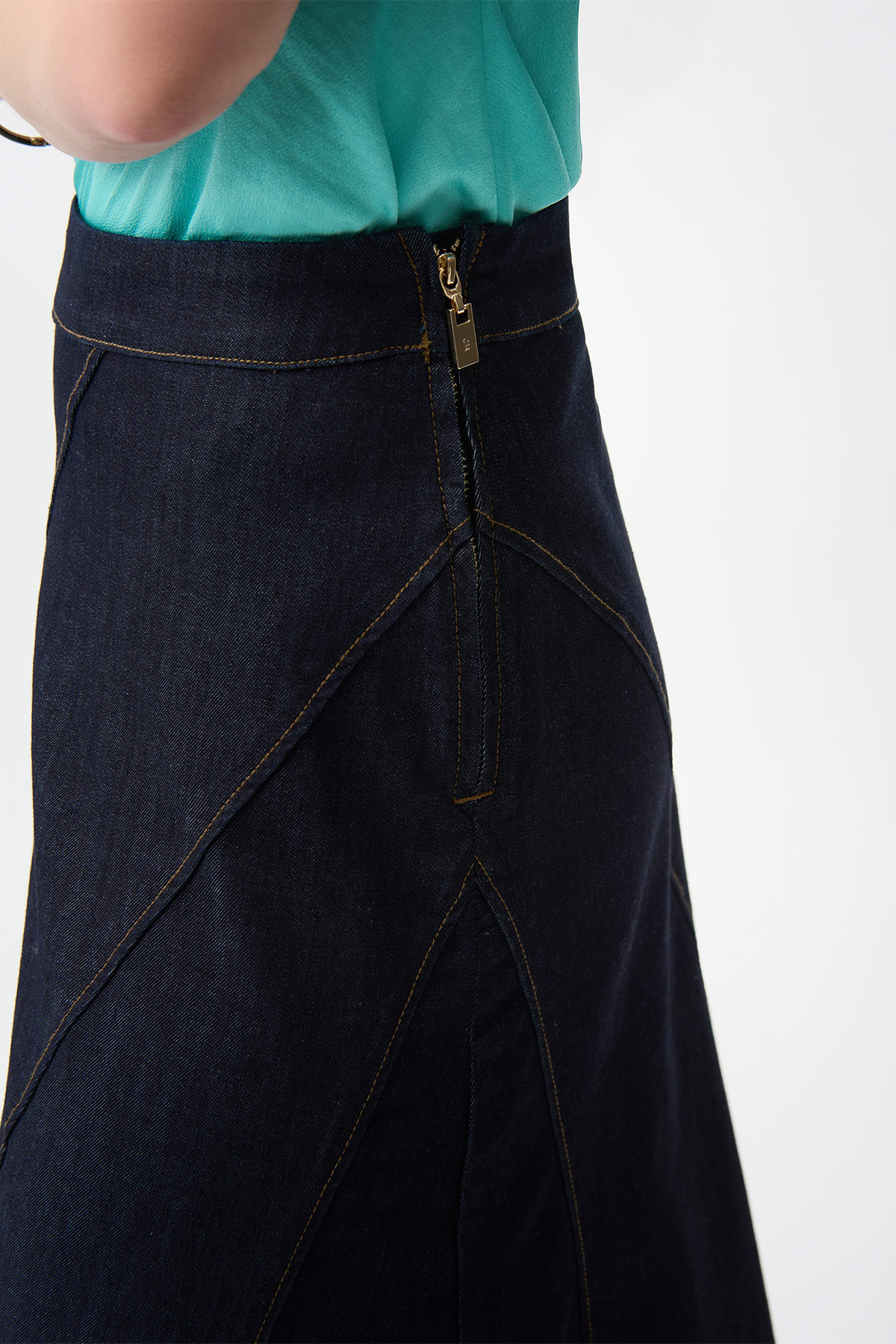Dark denim skirt with a gold zipper on a white background