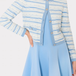 Woman wearing a blue and white striped cardigan over a light blue dress on a white background