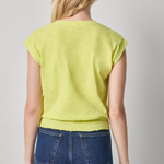 back of woman in vneck yellow shirt on white background 