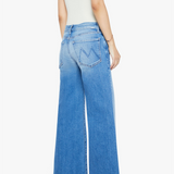 Person wearing blue jeans and a white top on a white background