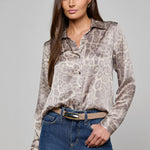 Long-sleeve blouse with a smooth, polished finish.