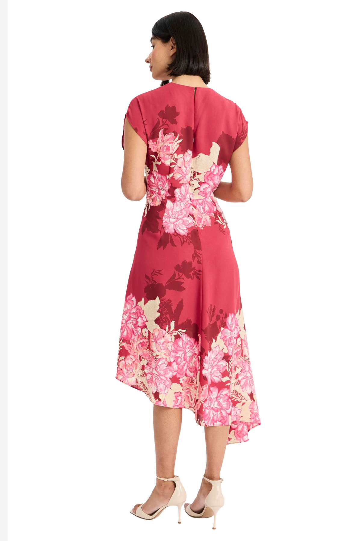 Model wearing a vibrant pink printed short-sleeve midi dress with an asymmetrical hem and flowing silhouette.