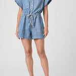 Denim romper worn by a model on a white background