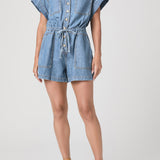 Denim romper worn by a model on a white background
