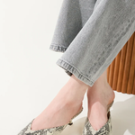 snakeskin kitten heels on white background 