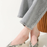 snakeskin kitten heels on white background 