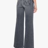 A model shown from the back wearing a pair of wide-leg, high-waisted gray denim jeans with a distinctive 'W' logo on the back pocket, paired with a black top and black heels against a plain white background.