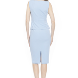 back of woman in blue midi dress on white background 