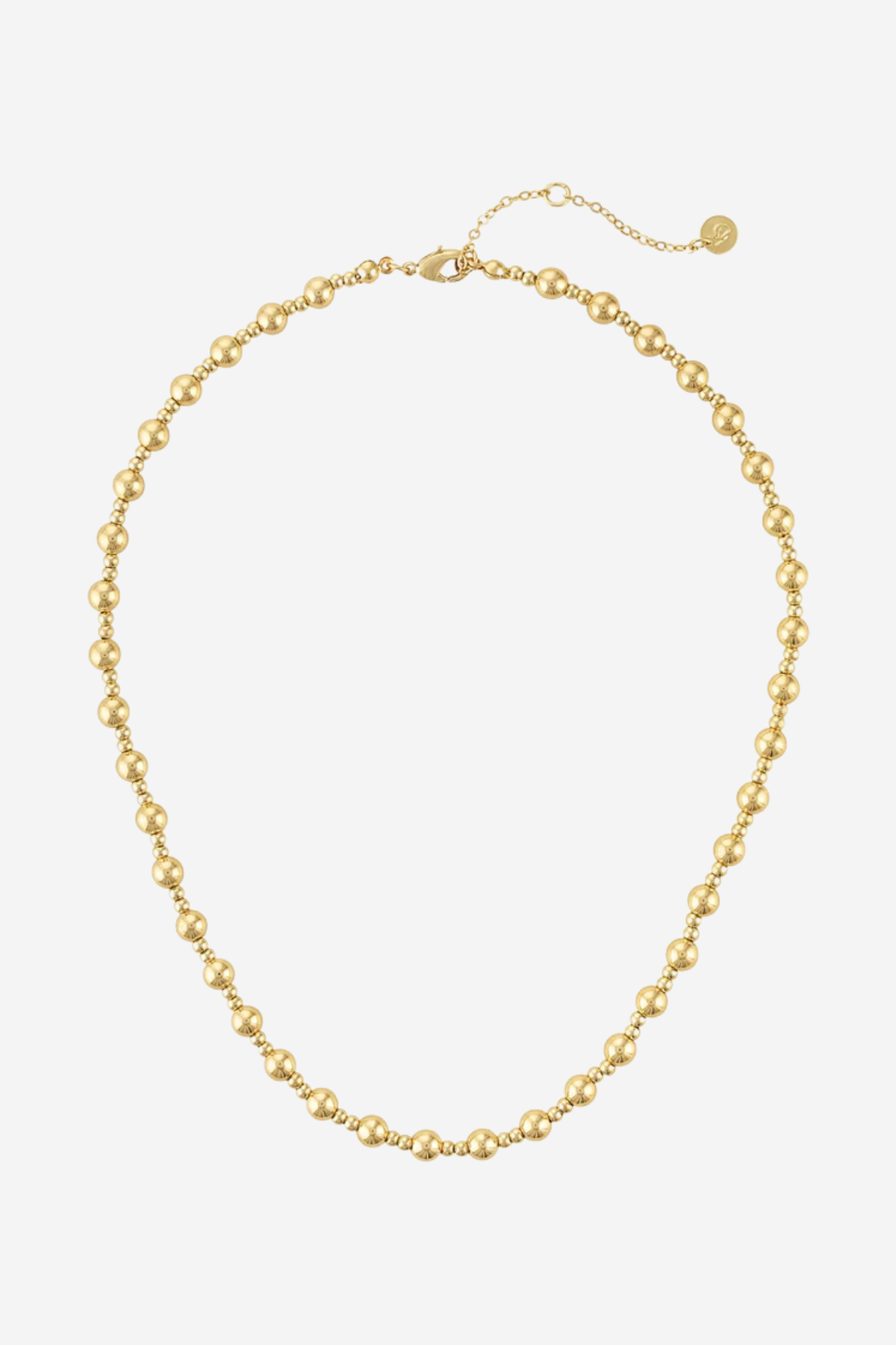 A gold beaded necklace with a delicate chain extender and a small round tag, displayed on a clean white background.