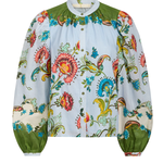 Colorful floral blouse with green accents on a white background